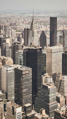 an aerial view of skyscrapers in new york city, with the empire building at the far end