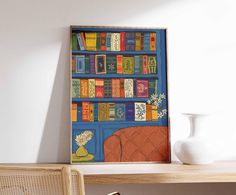 a book shelf filled with lots of books next to a white vase and wooden chair