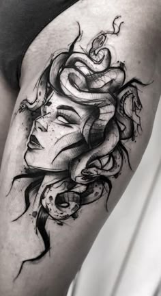 a woman's thigh with a tattoo design on it