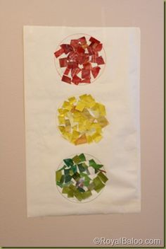 three different colored pieces of glass sitting on top of a piece of paper