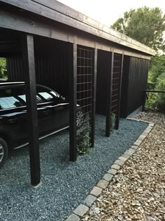 a black car parked in front of a building with metal bars on the sides and windows