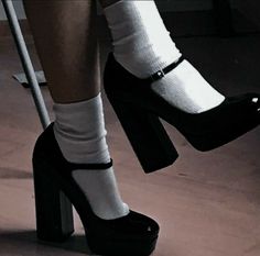 a woman's legs with white socks and high heels