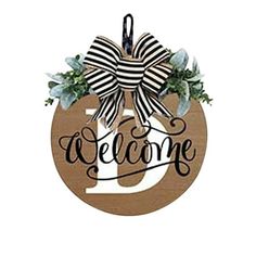 a wooden sign that says welcome with a bow