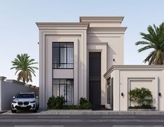 a car is parked in front of a two story house with palm trees on both sides