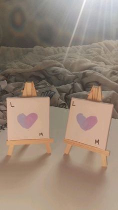 two small easels with hearts painted on them