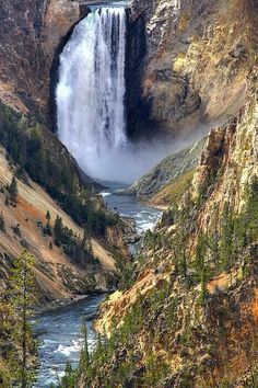 a large waterfall in the middle of a canyon