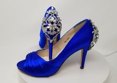 "Blue Bridal Shoes with a full crystal back design. Dyeable Wedding Shoes. Bridal shoes available in over 100 additional colors, including white and ivory. We can also color match a sample you send us. These beautiful wedding shoes have a 3 1/2\" heel and a 1/2\" hidden platform. The listing shoes have been dyed my chart color Rio Sapphire. Pick from my color chart or send us a color swatch to match. **If you are concerned about ordering the correct shoe size, please consider purchasing my \"sur Silver And Blue Wedding, Bling Wedding Shoes, Shoes Royal Blue, Sparkly Wedding Shoes, Blue Bridal Shoes, Royal Blue Wedding Shoes, Custom Wedding Shoes, Light Blue Shoes, Beautiful Wedding Shoes