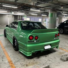 a green car parked in a parking garage