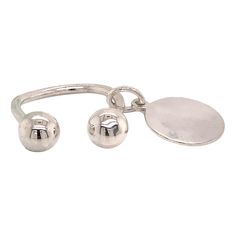 a silver bracelet with two balls and a disc on the clasp, both in different sizes