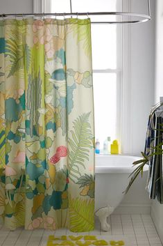 a bathroom with a bathtub, shower curtain and rug