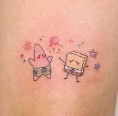 two cartoon characters on the back of a woman's stomach, one with a piece of cake