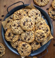 a blue bowl filled with cookies and raisins on top of a wooden table