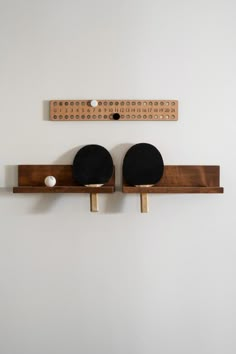 two ping pong paddles mounted to the wall