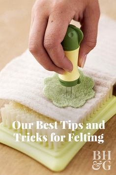 a person is using a sponge to clean the dust on top of a cleaning brush