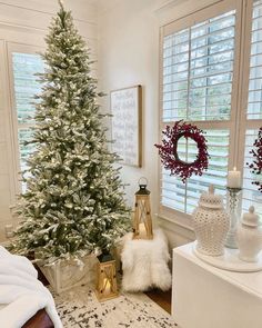 a white christmas tree in the corner of a room