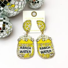 Beads, Pearls, and Crystals Yellow Can Earrings with Lemon Slice Studs. Pictured on a white background with disco balls in the top left. Can Earrings, Giddy Up Glamour, Lemon Slice, Lovely Earrings, Can Design, White Beads, Sale Items, 1 Inch, Lemon