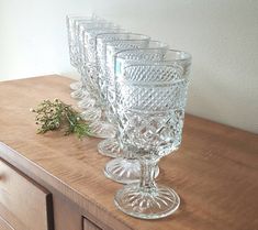 there are four glasses sitting on the counter next to each other and one is empty