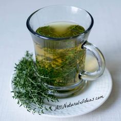 a glass cup filled with green tea on top of a white plate