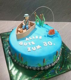 a birthday cake with a fishing theme on the bottom and an image of a man in a boat