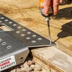 a person using a drill to cut wood planks with a cordless screwdriver