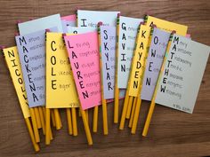 several pieces of paper with words on them sitting on a table next to pencils