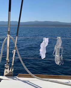 clothes hanging on the side of a boat in the ocean