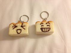 two pieces of bread with faces drawn on them, one is shaped like a toast