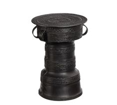 a black metal stool with an intricate design on the top