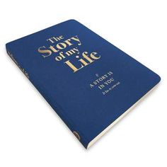 the story of my life is written in gold on a blue book cover