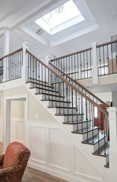 a living room filled with furniture and a stair case