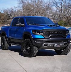 a blue truck parked in a parking lot