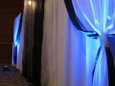 the curtains are open and ready to be used as backdrops for a wedding ceremony