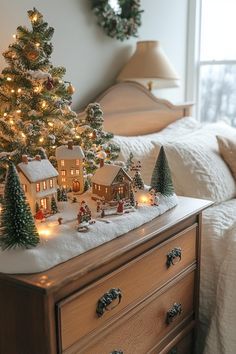 a small christmas tree on top of a dresser