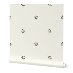 a white wallpaper with small green leaves on the top and bottom half of it