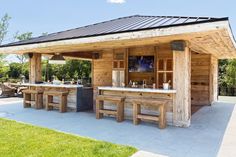 an outdoor bar with wooden tables and benches