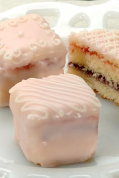 three pieces of cake sitting on top of a white plate