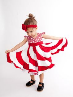 This boutique dress was designed with candy cane kisses and daydreams of candy land in mind. Inspired by the magic of childhood, and the promise of eternal sweetness, this designer dress captures waves of white and red tones and contrasts them against a peppermint candy bodice. The result is a dress that is meant to be twirled and swirled until your little princess can't help fall into the giggles. Each of these dresses are made to order with all seams serged for a professional finish. The purch Playful Ruffled Dresses For Holidays, Playful Holiday Dresses With Ruffles, Playful Red Party Dress, Cute Red Holiday Dress, Sweet Red Dress With Ruffles, Playful Fitted Red Dress, Playful Ruffled Holiday Dresses, Fun Red Dress-up Dresses, Peppermint Bardon Dress