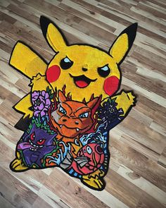 a pokemon rug with an image of pikachu and other cartoon characters on it