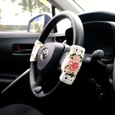 a car dashboard with a steering wheel and flowers on it