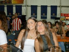 two women sitting next to each other at a table