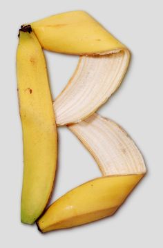 two bananas cut in half on top of each other with the peels still attached