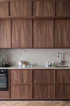 a kitchen with wooden cabinets and an oven