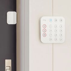 a remote control is on the wall next to a door handle and keypads