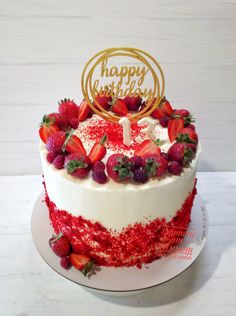 a birthday cake with strawberries on top