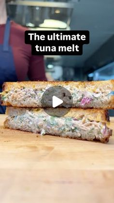 the ultimate tuna melt sandwich is cut in half and ready to be eaten by someone