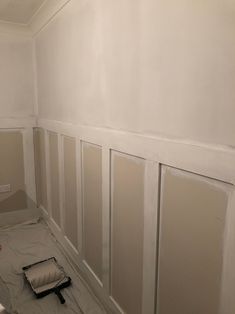 an empty room with white walls and paint on the walls