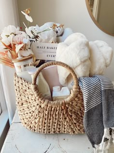 a basket filled with lots of items on top of a white counter next to a mirror