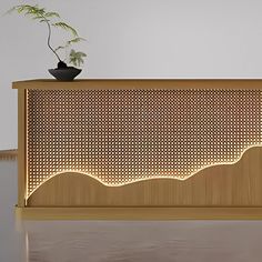 a plant is sitting on top of a wooden table with lights in the shape of waves