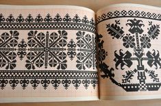 an open book with black and white designs on it