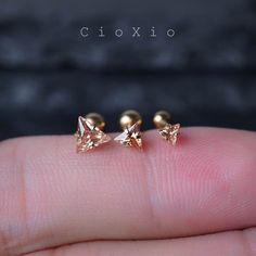 the tiny gold studs are set on top of each other's thumbnails